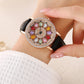 Montre à cadran rotatif pour femme avec diamants simulés colorés