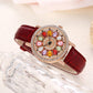Montre à cadran rotatif pour femme avec diamants simulés colorés