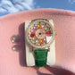 Montre à cadran rotatif pour femme avec diamants simulés colorés